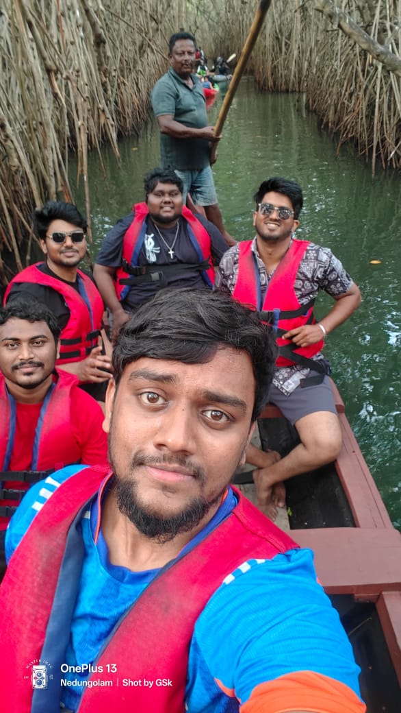 Group paddling a country boat through a mangrove tunnel