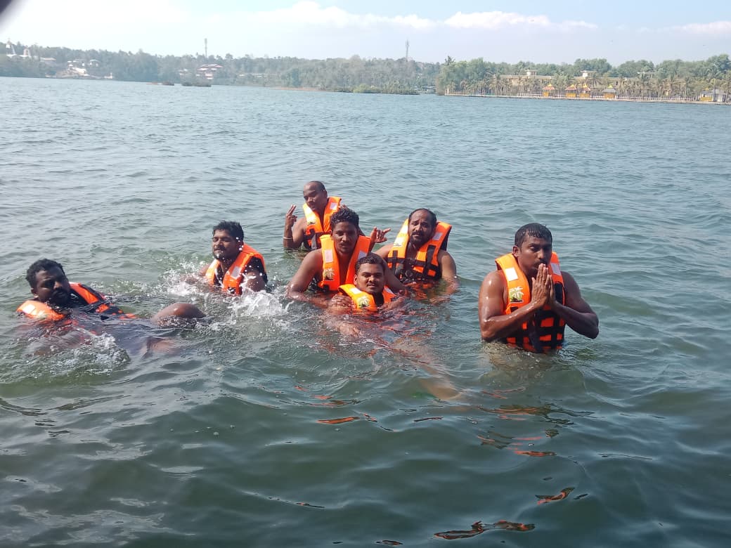 Group enjoying the lake in life jackets