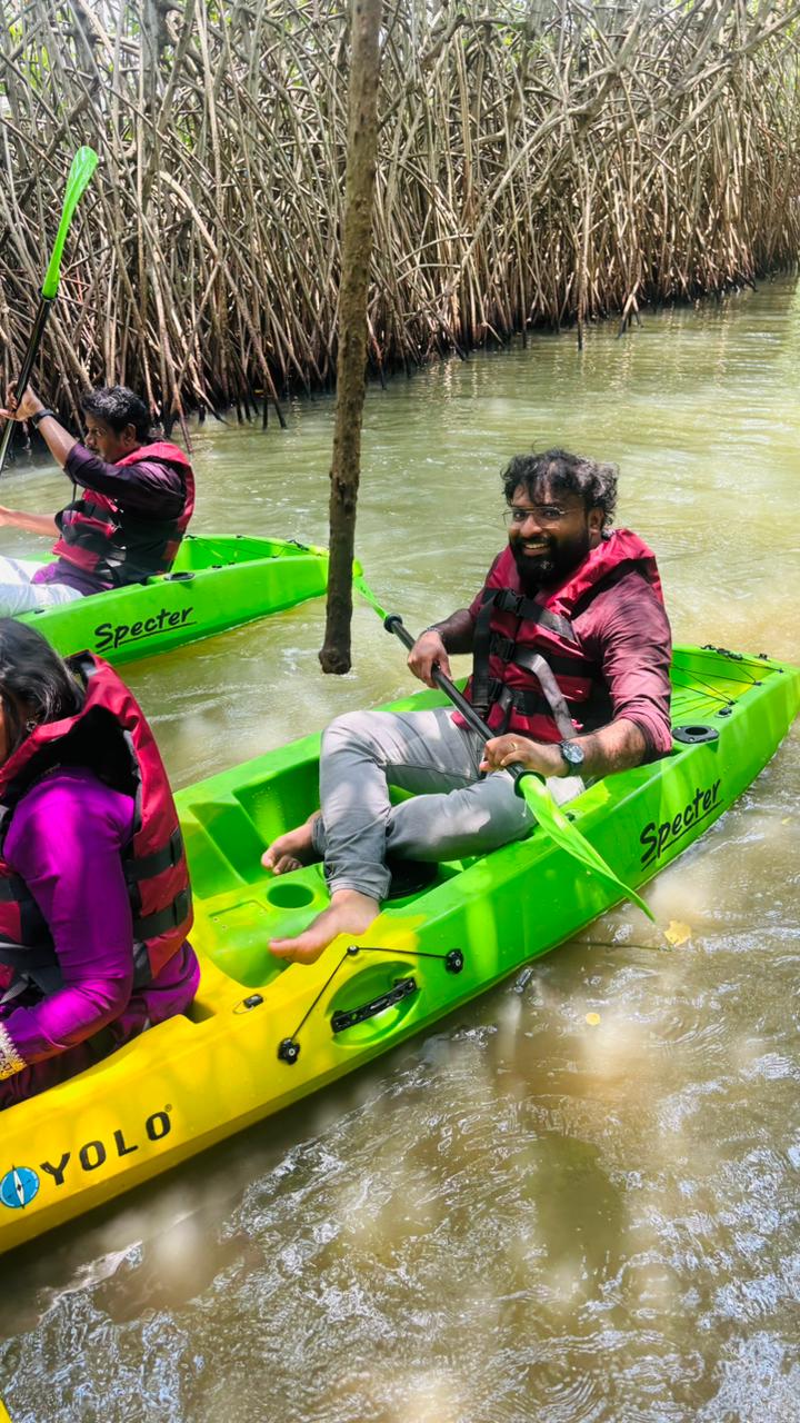 Smiling paddler in a green kayak